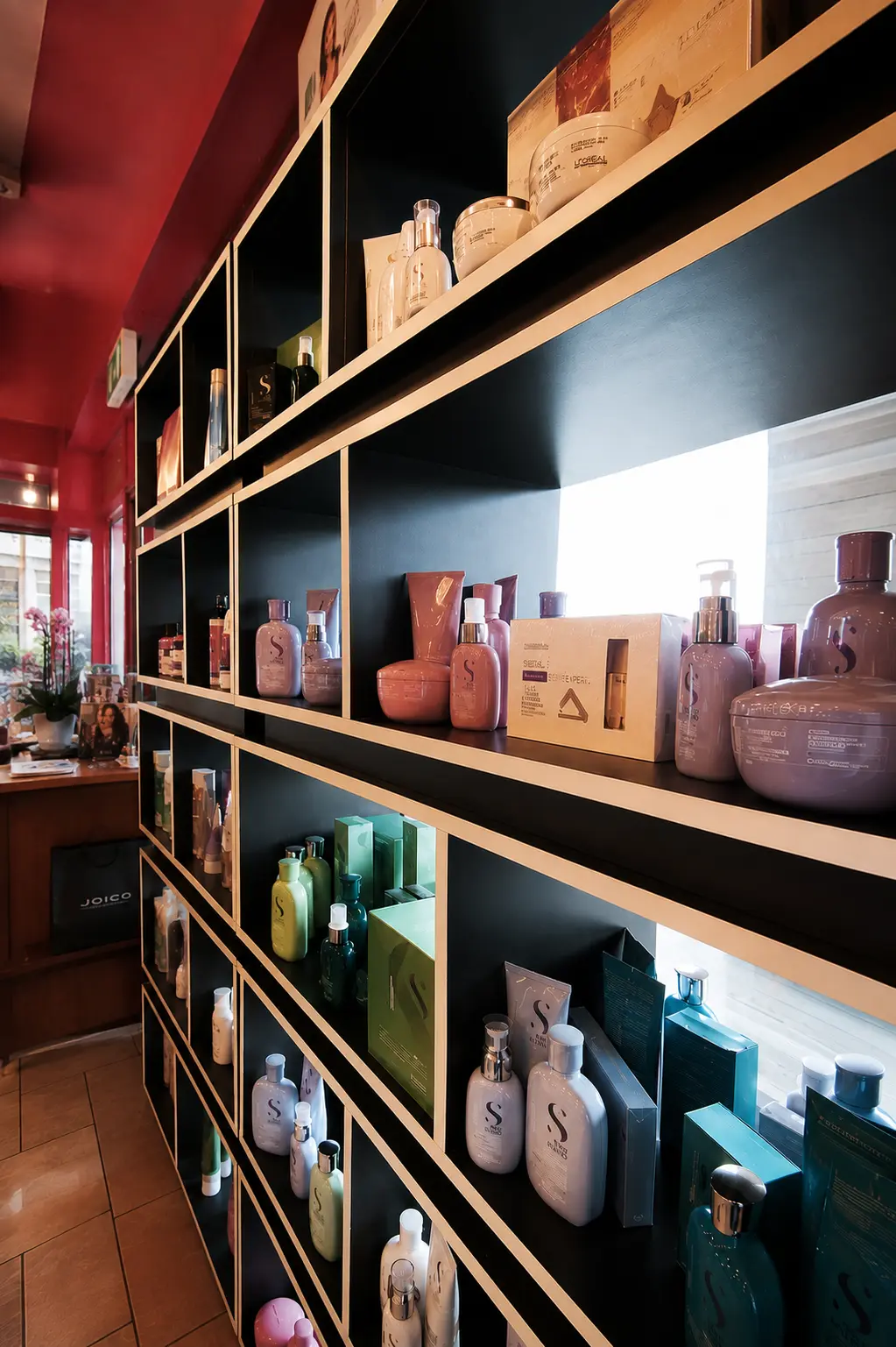 Retail shelving stocked with professional hair and beauty products