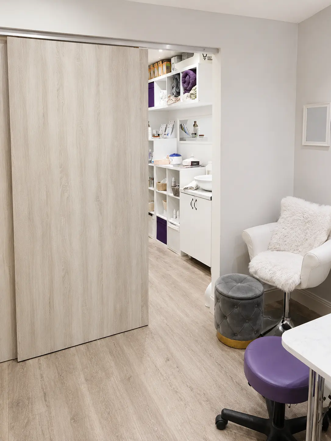Bright beauty treatment room with a comfortable armchair